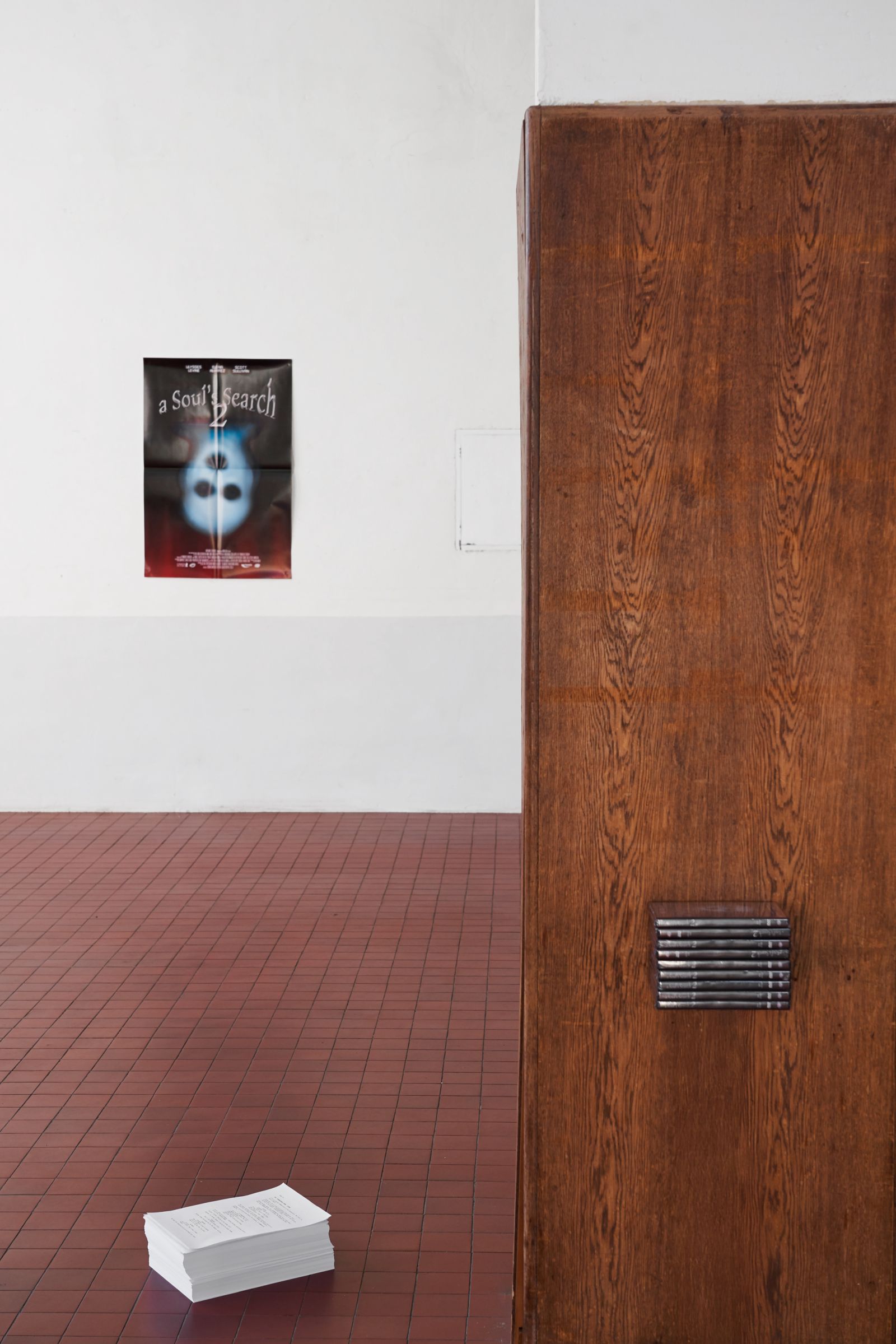 Exhibition view showing a poster of 