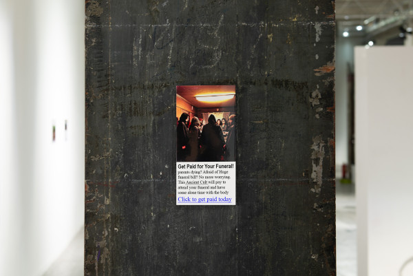 a small print hanging on a worn concrete column, the print is of a clickbait advert that offers a service to get paid for your funeral by allowing an ancient cult to have some private time with the corpse before burial