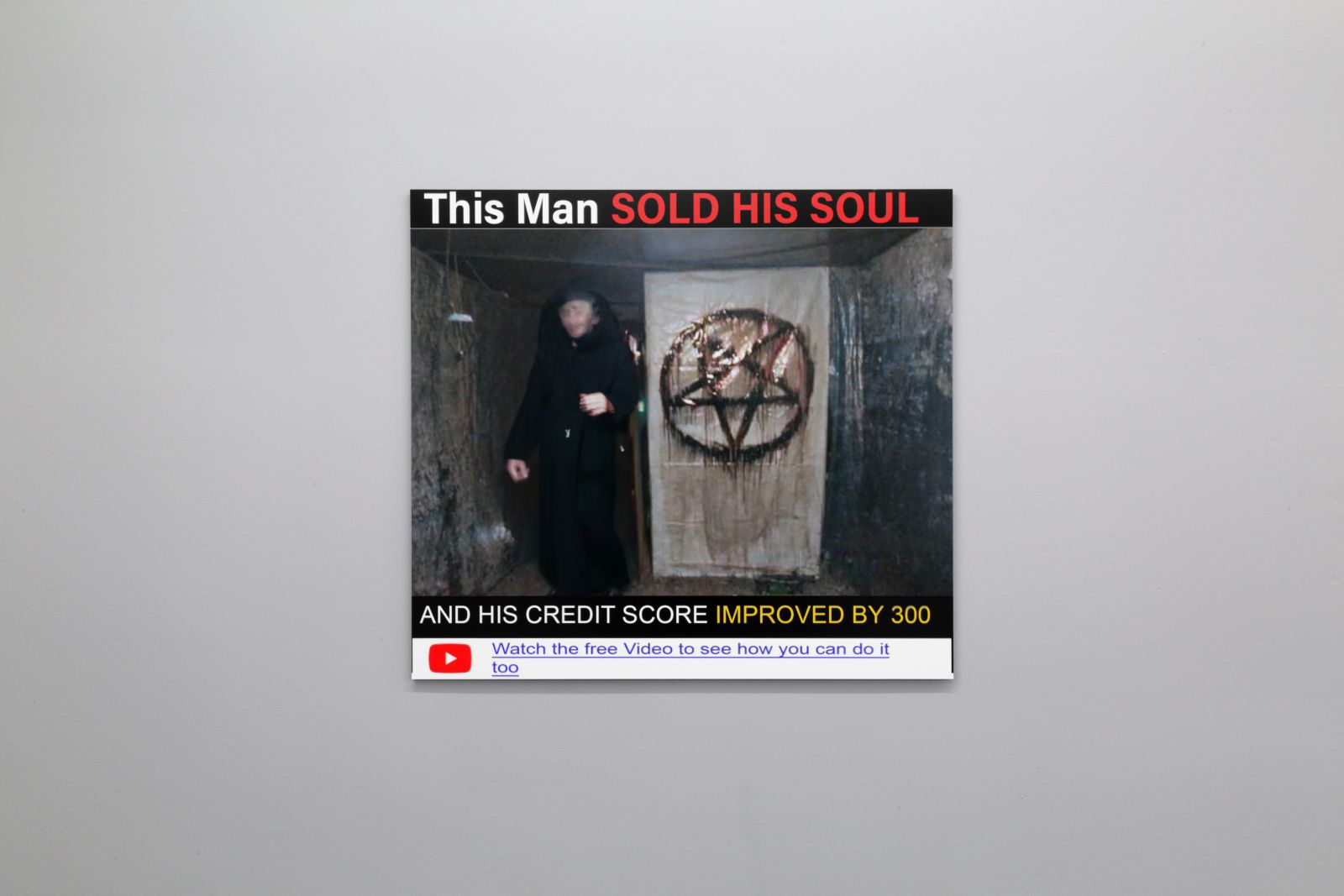 print hanging on lightgrey wall, print resembles an online clickbait advert with a trick for improving your credit score by selling your soul