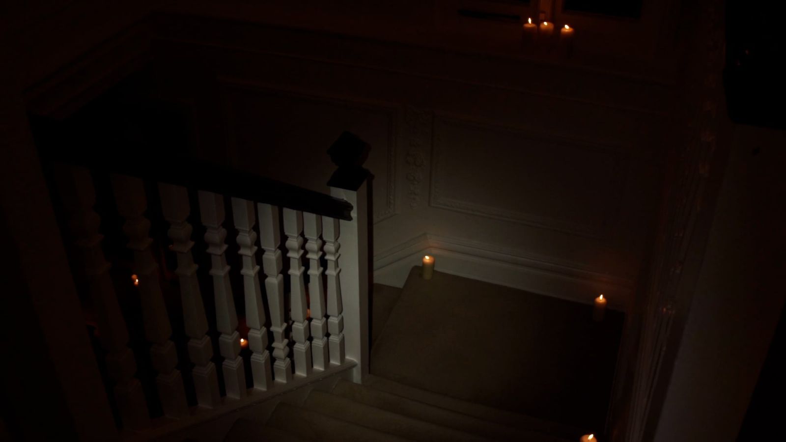 Still from Alison (2021) by Melle Nieling, descending a dark staircase
