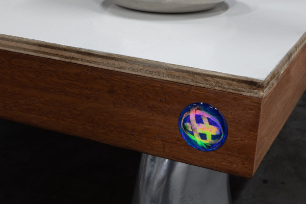 A close up of a blue 3d dome sticker with holographic effect